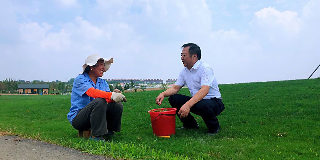 巫蘇明與在伏熱花海項目基地打工的村民交流.jpg